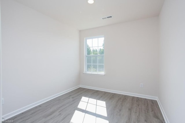 unfurnished room with light wood-type flooring