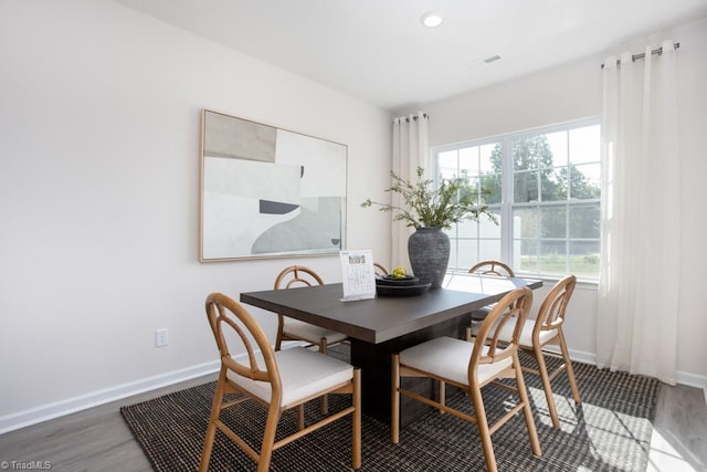 dining area with dark hardwood / wood-style flooring