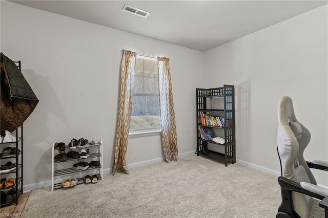 home office with light carpet, visible vents, and baseboards