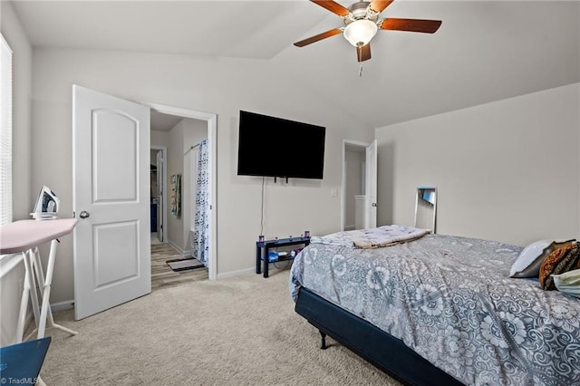 bedroom featuring lofted ceiling, baseboards, carpet floors, and ceiling fan