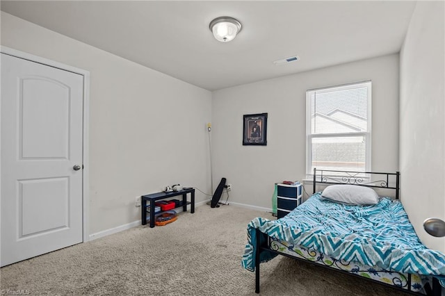 carpeted bedroom with baseboards and visible vents