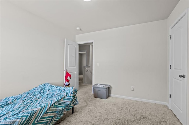 bedroom featuring carpet and baseboards