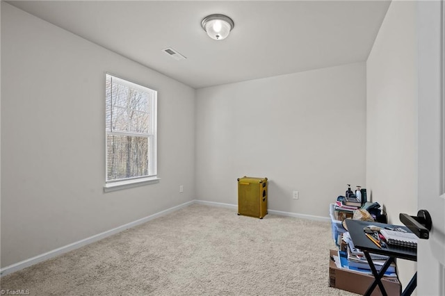 home office featuring light carpet, visible vents, and baseboards