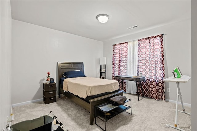 bedroom featuring light colored carpet, visible vents, and baseboards