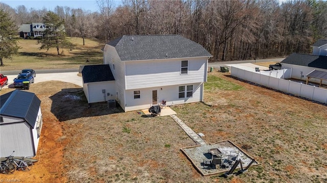 back of property with central AC unit and fence