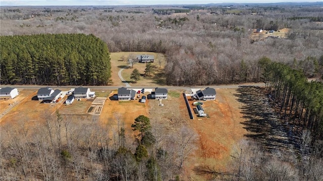 drone / aerial view featuring a wooded view