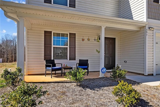 view of exterior entry with a porch