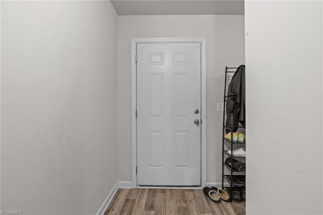 entryway featuring baseboards and light wood-style floors