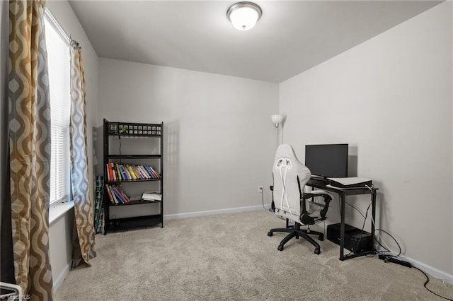 office space with light carpet and baseboards