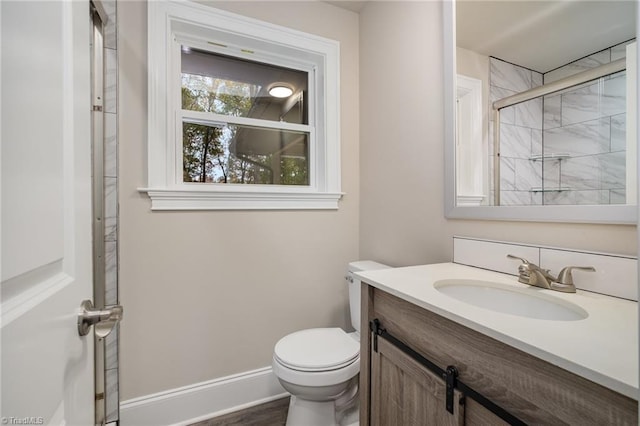 bathroom with vanity, toilet, and an enclosed shower