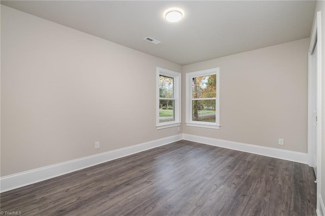 unfurnished room featuring dark hardwood / wood-style floors