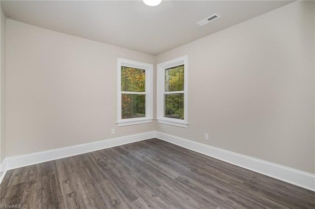 unfurnished room with dark hardwood / wood-style floors