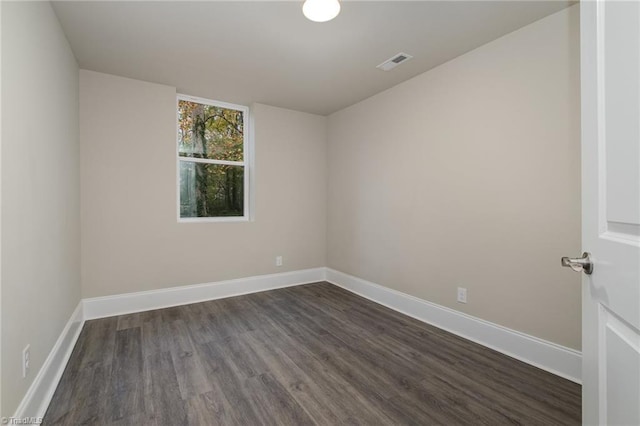 spare room with dark hardwood / wood-style flooring