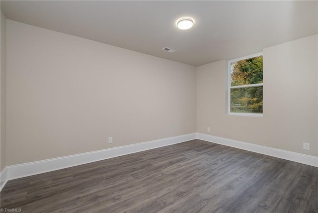 unfurnished room featuring dark wood-type flooring