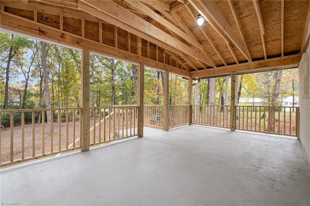 unfurnished sunroom with lofted ceiling