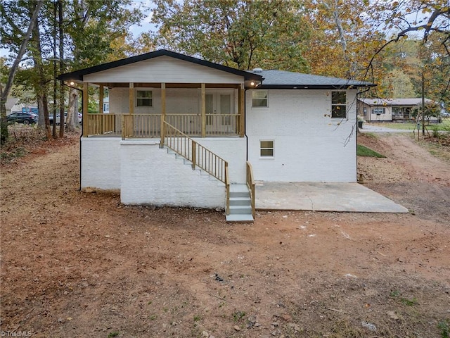 back of house featuring covered porch