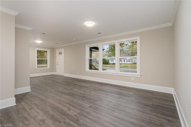 spare room featuring dark hardwood / wood-style floors and ornamental molding