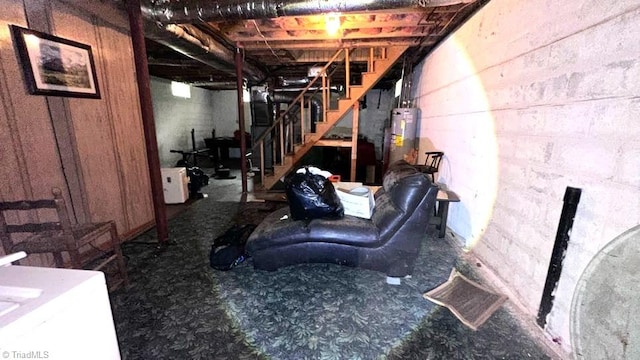 225 Dan Bryant Rd, Pilot Mountain, NC 27041 - unfinished below grade area featuring stairway, gas water heater, carpet flooring, and concrete block wall