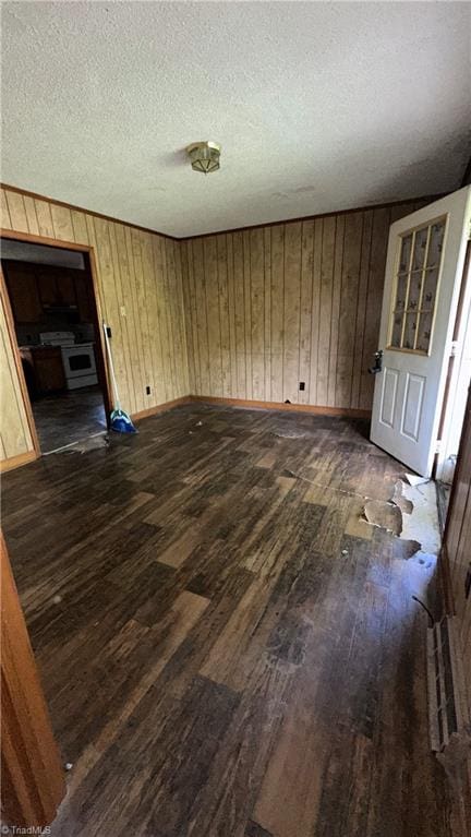 225 Dan Bryant Rd, Pilot Mountain, NC 27041 - empty room featuring dark wood-style flooring, a textured ceiling, wood walls, and baseboards