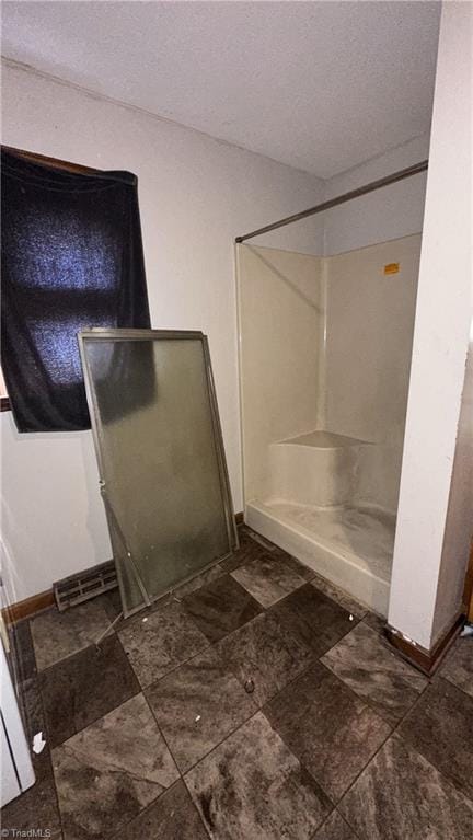 225 Dan Bryant Rd, Pilot Mountain, NC 27041 - full bath with baseboards, a textured ceiling, and a walk in shower