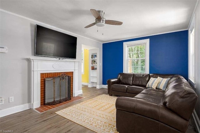 3006 Collier Dr, Greensboro, NC 27403 - living area with wood finished floors, crown molding, a ceiling fan, and a fireplace