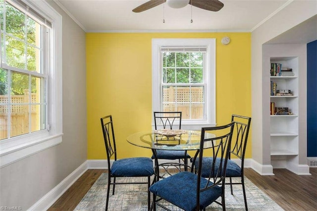 3006 Collier Dr, Greensboro, NC 27403 - dining space featuring dark wood finished floors, a ceiling fan, ornamental molding, and built in shelves