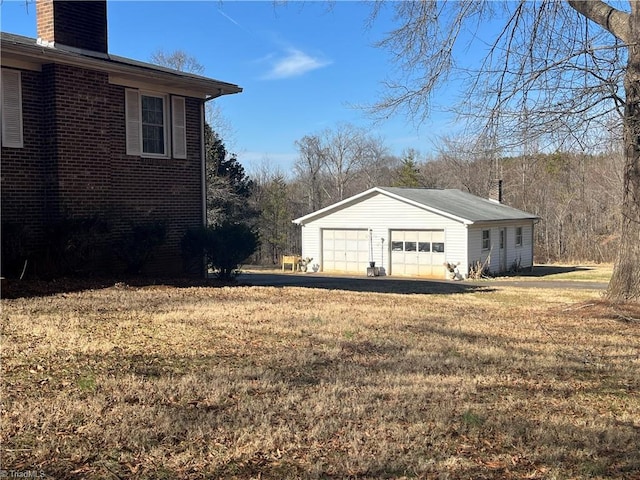 view of yard with a garage and an outdoor structure