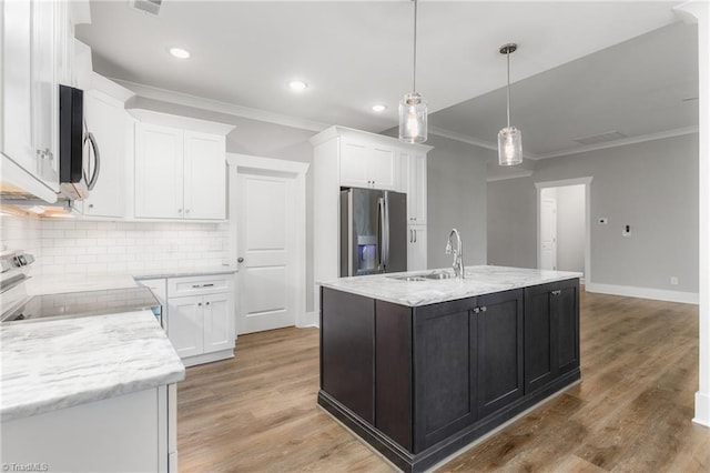 kitchen featuring range, a center island with sink, sink, stainless steel refrigerator with ice dispenser, and white cabinetry