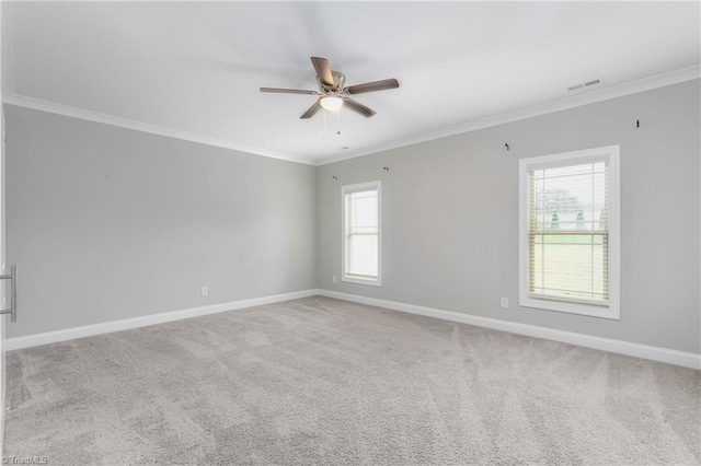 carpeted empty room with plenty of natural light and crown molding