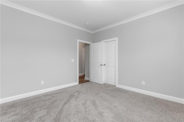 carpeted empty room featuring ornamental molding