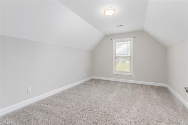 bonus room with lofted ceiling and carpet floors