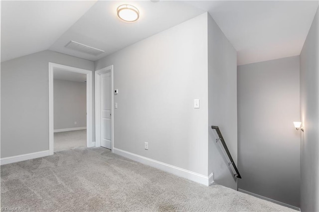 additional living space with lofted ceiling and light carpet