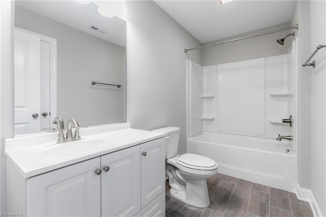 full bathroom with shower / washtub combination, hardwood / wood-style floors, vanity, and toilet