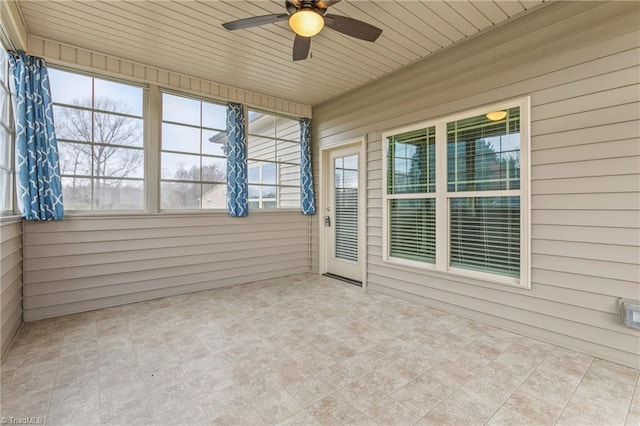 unfurnished sunroom with ceiling fan and wooden ceiling