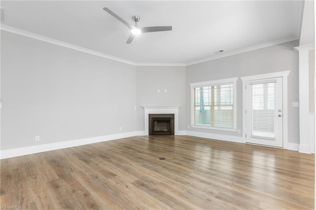 unfurnished living room featuring ceiling fan, ornamental molding, and light hardwood / wood-style flooring