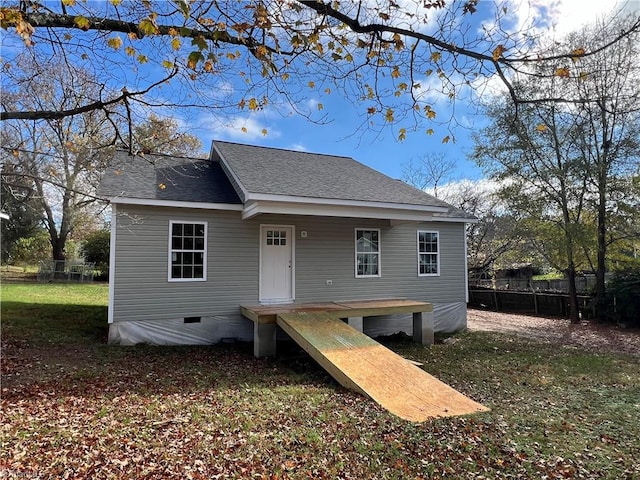 back of house with a lawn