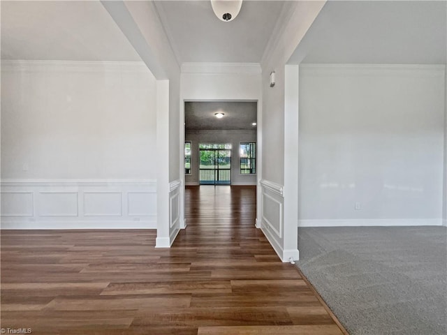 foyer featuring crown molding and dark wood-type flooring