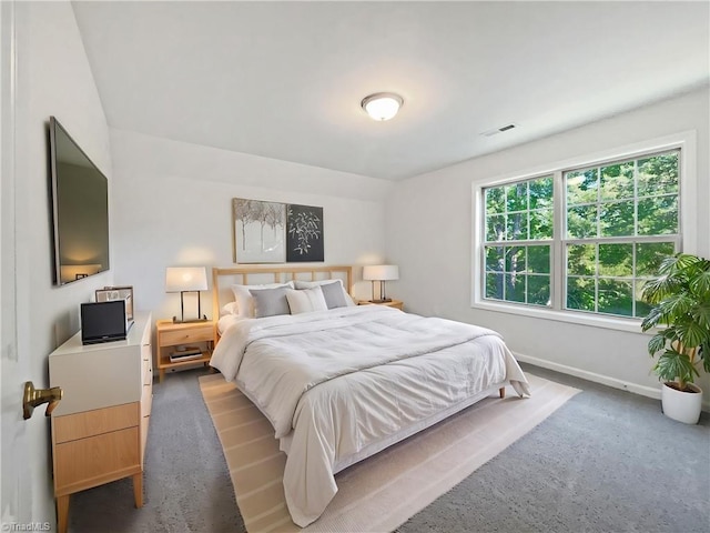 carpeted bedroom featuring visible vents and baseboards