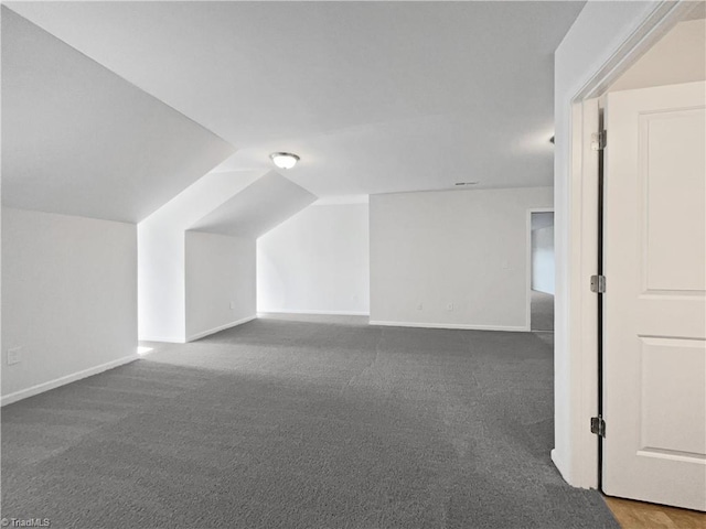bonus room featuring carpet, baseboards, and lofted ceiling