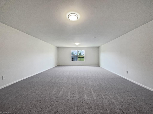empty room with carpet floors and baseboards