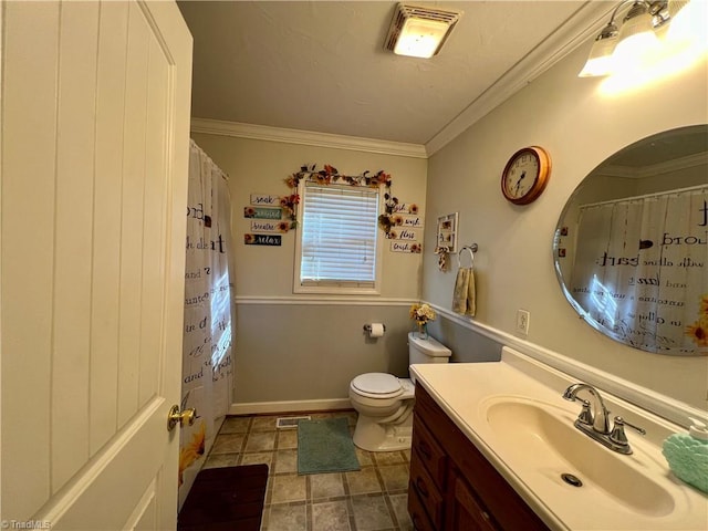 bathroom featuring vanity, ornamental molding, and toilet