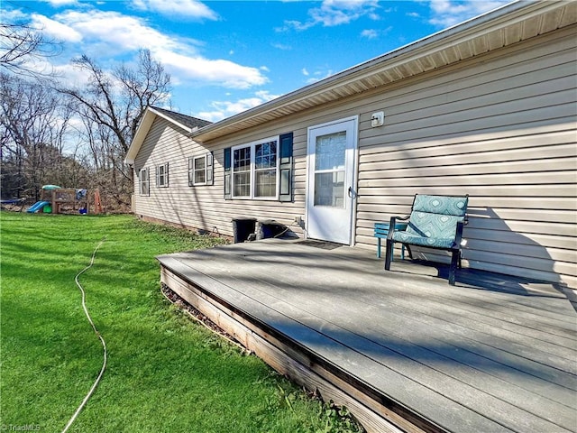 wooden deck featuring a yard and a playground