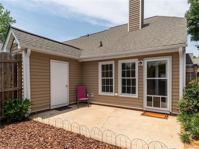 10 Cedar Knoll Ct, Greensboro, NC 27407 - rear view of property with roof with shingles, a patio area, and a chimney