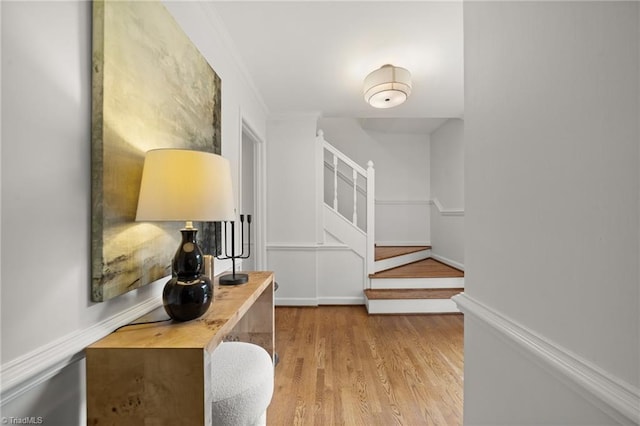 3408 Deep Green Dr, Greensboro, NC 27410 - hallway with wood finished floors, stairway, ornamental molding, and baseboards
