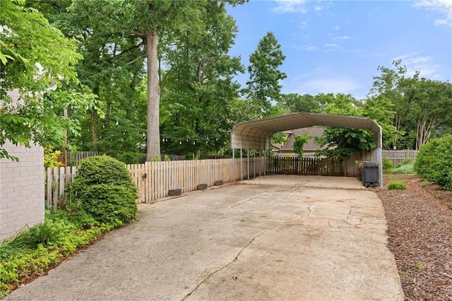 3408 Deep Green Dr, Greensboro, NC 27410 - view of patio / terrace featuring a detached carport, driveway, and fence