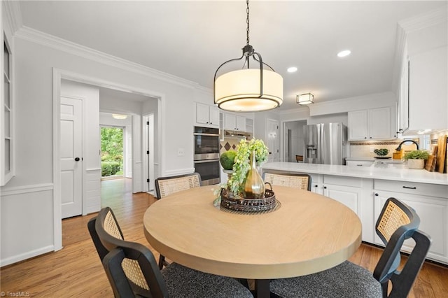 3408 Deep Green Dr, Greensboro, NC 27410 - dining space with light wood-style floors, crown molding, and recessed lighting