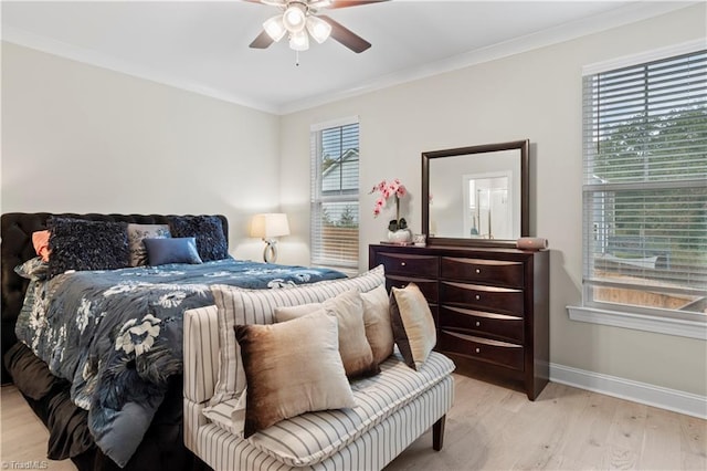 bedroom featuring ceiling fan, crown molding, and light hardwood / wood-style floors