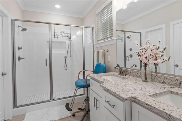 bathroom with vanity, crown molding, and walk in shower