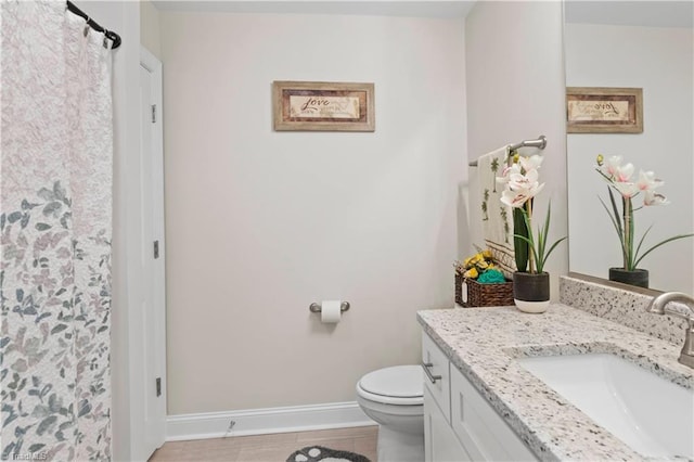 bathroom with tile patterned floors, vanity, and toilet