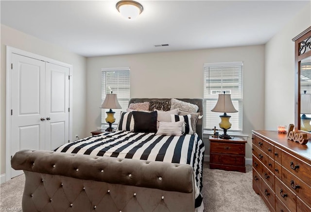 carpeted bedroom featuring a closet